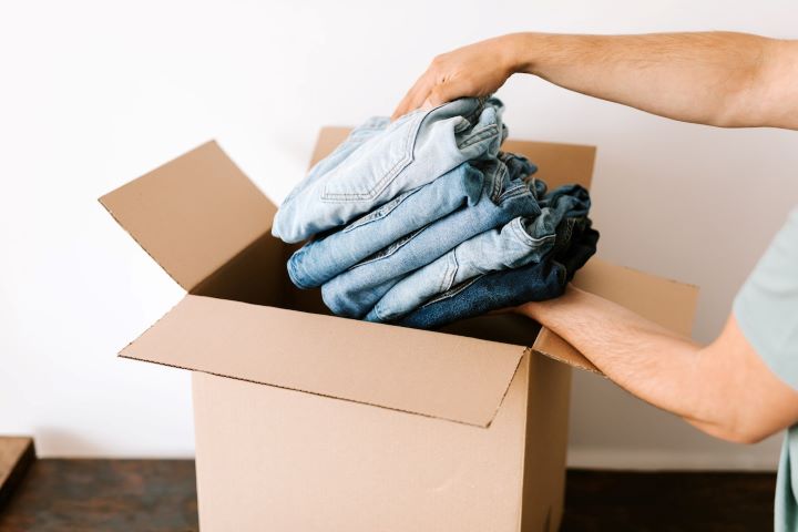 one of the most important tips on how to stage your home is to declutter it like this person is decluttering their wardrobe